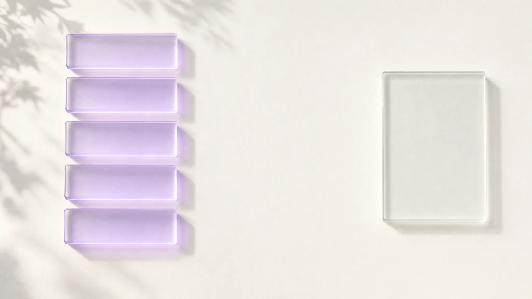 Overhead view of five glowing violet glass slabs stacked together beside a single larger unlit slab sitting alone in empty space
